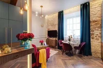 a living room with a table and chairs and a dining room at Charming apartment next to the Church of St Anne by Reside Baltic in Vilnius