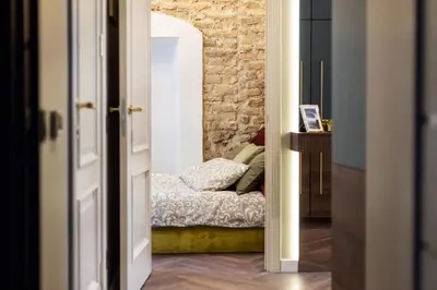 a bedroom with a bed in a brick wall at Charming apartment next to the Church of St Anne by Reside Baltic in Vilnius