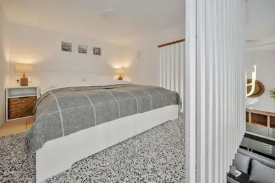 a white bedroom with a bed and a window at Stylish Apartment in Vilnius Old Town/ URBAN RENT in Vilnius