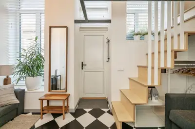 a living room with a couch and a stair case at Stylish Apartment in Vilnius Old Town/ URBAN RENT in Vilnius