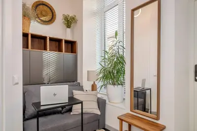 a living room with a couch and a laptop on a table at Stylish Apartment in Vilnius Old Town/ URBAN RENT in Vilnius