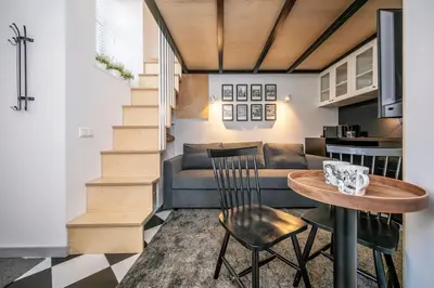 a living room with a table and a couch at Stylish Apartment in Vilnius Old Town/ URBAN RENT in Vilnius