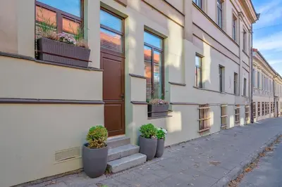 a building with potted plants on the side of it at Stylish Apartment in Vilnius Old Town/ URBAN RENT in Vilnius