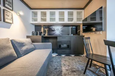 a living room with a couch and a kitchen at Stylish Apartment in Vilnius Old Town/ URBAN RENT in Vilnius
