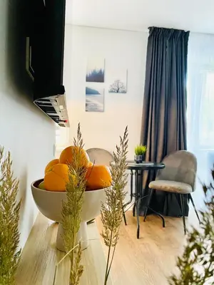 a bowl of oranges on a table in a room at Alyvų tako studija in Alytus