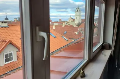 a window with a view of a city at Meshka's Apartment in Vilnius