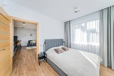 a bedroom with a bed and a large window at Lovely Apartment with Private Terrace by URBAN RENT in Kaunas