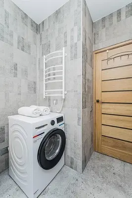 a laundry room with a washing machine and a door at Lovely Apartment with Private Terrace by URBAN RENT in Kaunas