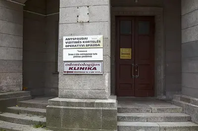 a sign on the side of a building with a door at Vilnius Centre Flat in Vilnius