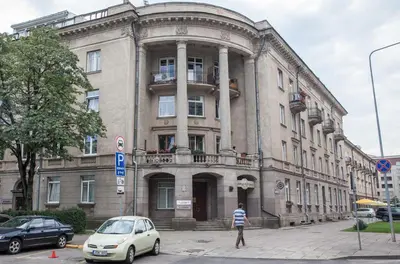 a man is standing in front of a building at Vilnius Centre Flat in Vilnius