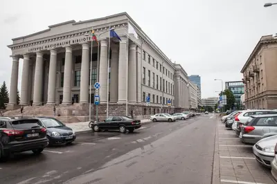 a large building with cars parked in front of it at Vilnius Centre Flat in Vilnius