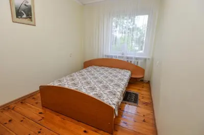 a small bedroom with a bed and a window at Poilsis prie Dineikos parko in Druskininkai