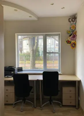 an office with a desk with two chairs and a window at Authentic old studio house in Kaunas