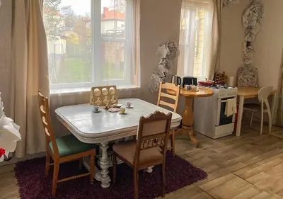 a kitchen with a table and chairs and a stove at Authentic old studio house in Kaunas
