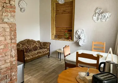 a living room with a couch and a table at Authentic old studio house in Kaunas