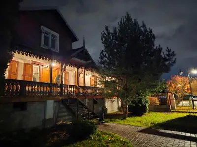 a house with lights on the side of it at night at Jeruzale Park view in Vilnius