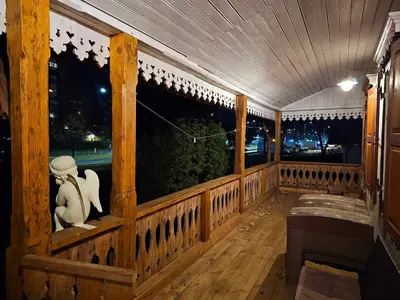 a wooden porch with a statue of a woman at Jeruzale Park view in Vilnius