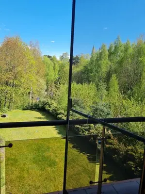a view from a window of a field and a river at Jeruzale Park view in Vilnius