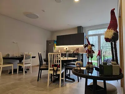 a living room with a dining room table with a santa hat at Miško Santorija in Ažuluokesa