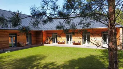 a house with a large yard in front of it at Miško Santorija in Ažuluokesa
