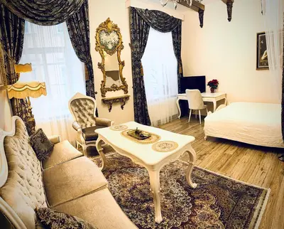 a living room with a couch and a table at Noble Apartments in Vilnius