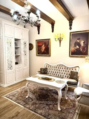 a living room with a white couch and a table at Noble Apartments in Vilnius