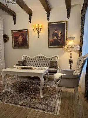 a living room with a couch and a table at Noble Apartments in Vilnius
