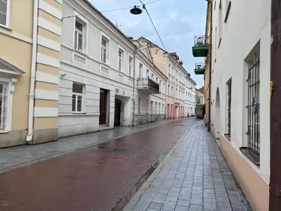 an empty street in a city with buildings at Noble Apartments in Vilnius