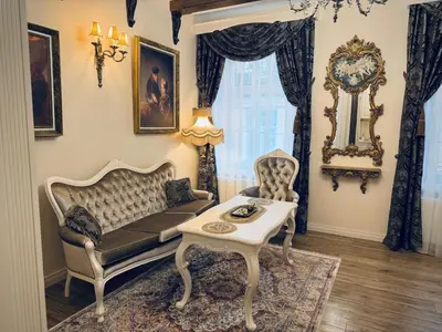 a living room with a couch and a table at Noble Apartments in Vilnius