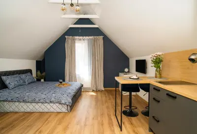 a bedroom with a bed and a desk in a room at Fort63 Studio in Kaunas