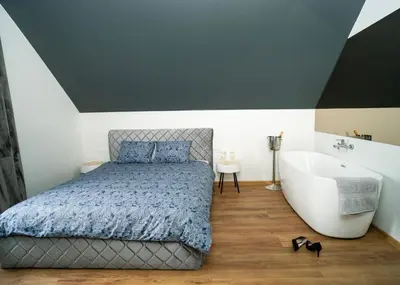 a bedroom with a bed and a bath tub at Fort63 Studio in Kaunas