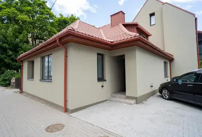 a house with a car parked in front of it at Fort63 Studio in Kaunas