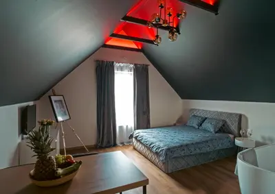 a living room with a bed and a table at Fort63 Studio in Kaunas