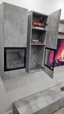 a fireplace with shelves and a tv on a wall at New apartment in the city in Šiauliai
