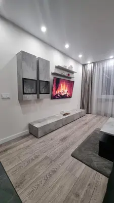 a living room with a fireplace on the wall at New apartment in the city in Šiauliai