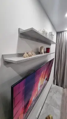 a living room with a tv and a fireplace at New apartment in the city in Šiauliai