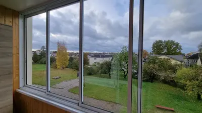a window with a view of a yard at New apartment in the city in Šiauliai