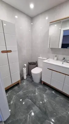 a white bathroom with a toilet and a sink at New apartment in the city in Šiauliai
