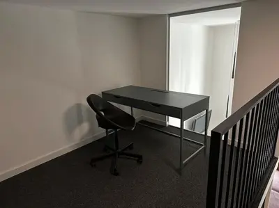 a black desk with a black chair in an office at M Loft3 in Kaunas