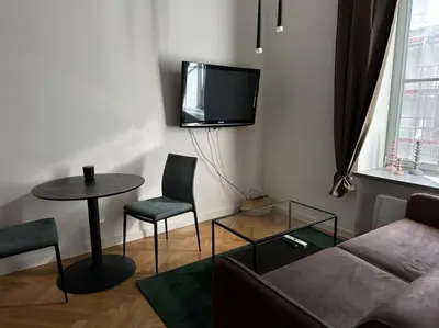 a living room with a couch and a table and a tv at M Loft3 in Kaunas