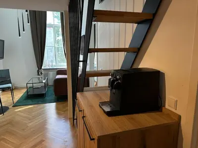 a microwave sitting on a wooden counter in a living room at M Loft3 in Kaunas