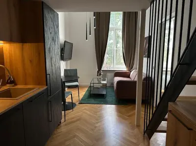 a living room with a couch and a table in a room at M Loft3 in Kaunas