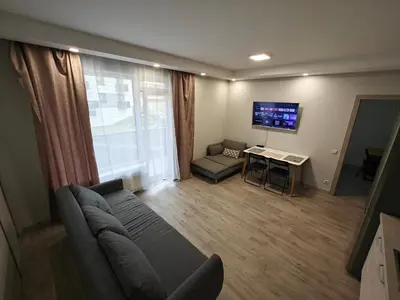 a living room with a couch and a table and a tv at Kavoliuko 14 in Vilnius