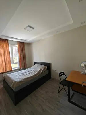 a bedroom with a bed and a desk and a table at Kavoliuko 14 in Vilnius