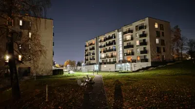 a large building at night with a building at Kavoliuko 14 in Vilnius