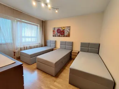 a bedroom with two beds and a window at Musninkų apartment near Akropolis in Vilnius