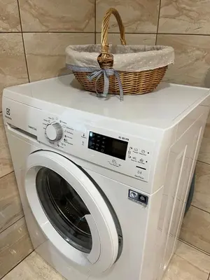a washing machine with a basket on top of it at Near Ozas in Vilnius