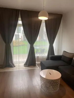 a living room with a couch and a table at Near Ozas in Vilnius