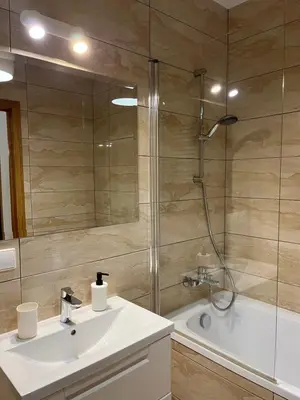 a bathroom with a shower and a sink and a tub at Near Ozas in Vilnius