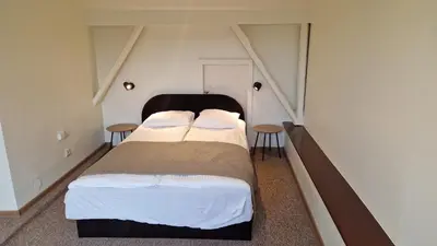 a bedroom with two beds and two tables at TyzenXL Luxury Vilnius Apartments in Vilnius